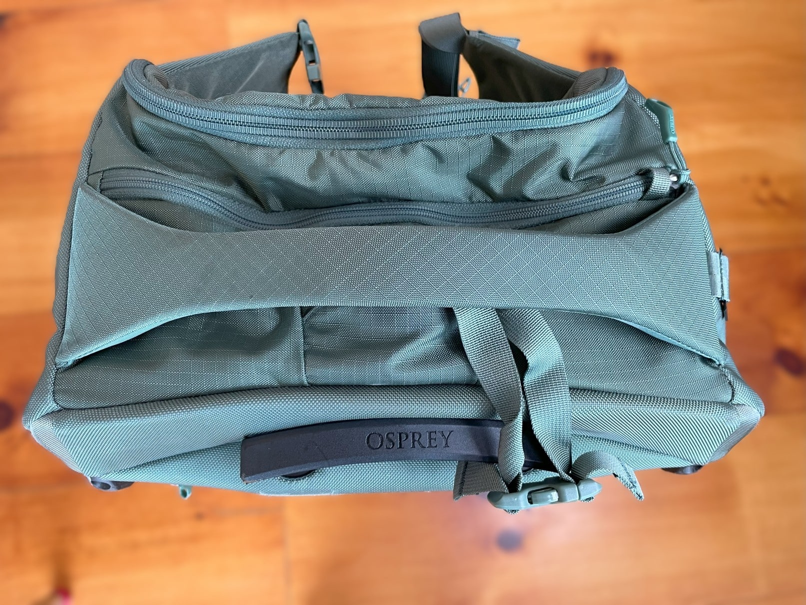 The large top grab handle and add-a-bag strap on the Osprey Sojourn Shuttle 100L.