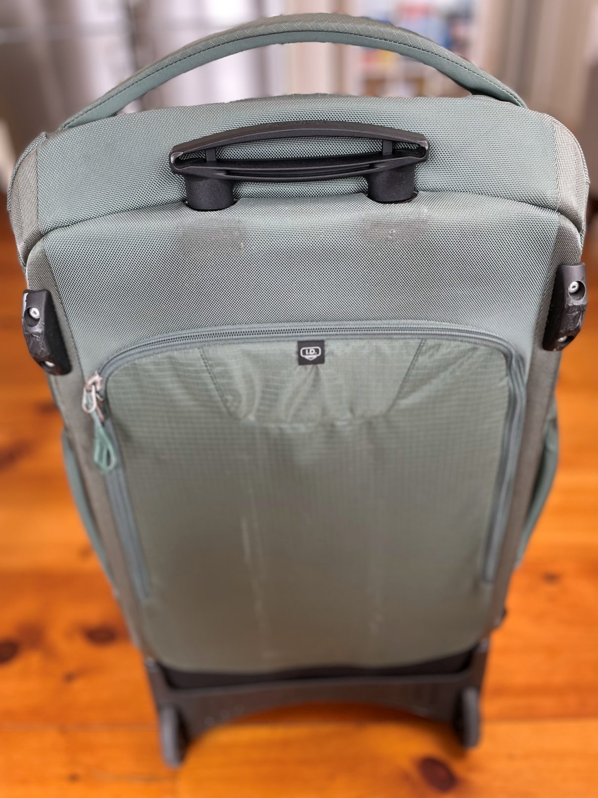 The rear of the Osprey Sojourn Shuttle 100L travel duffel.