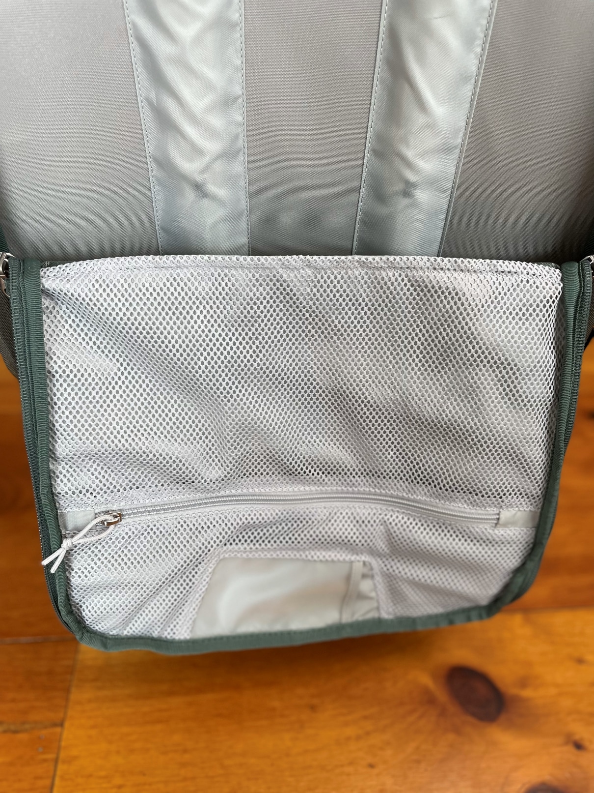 The rear pocket of the Osprey Sojourn Shuttle 100L travel duffel.