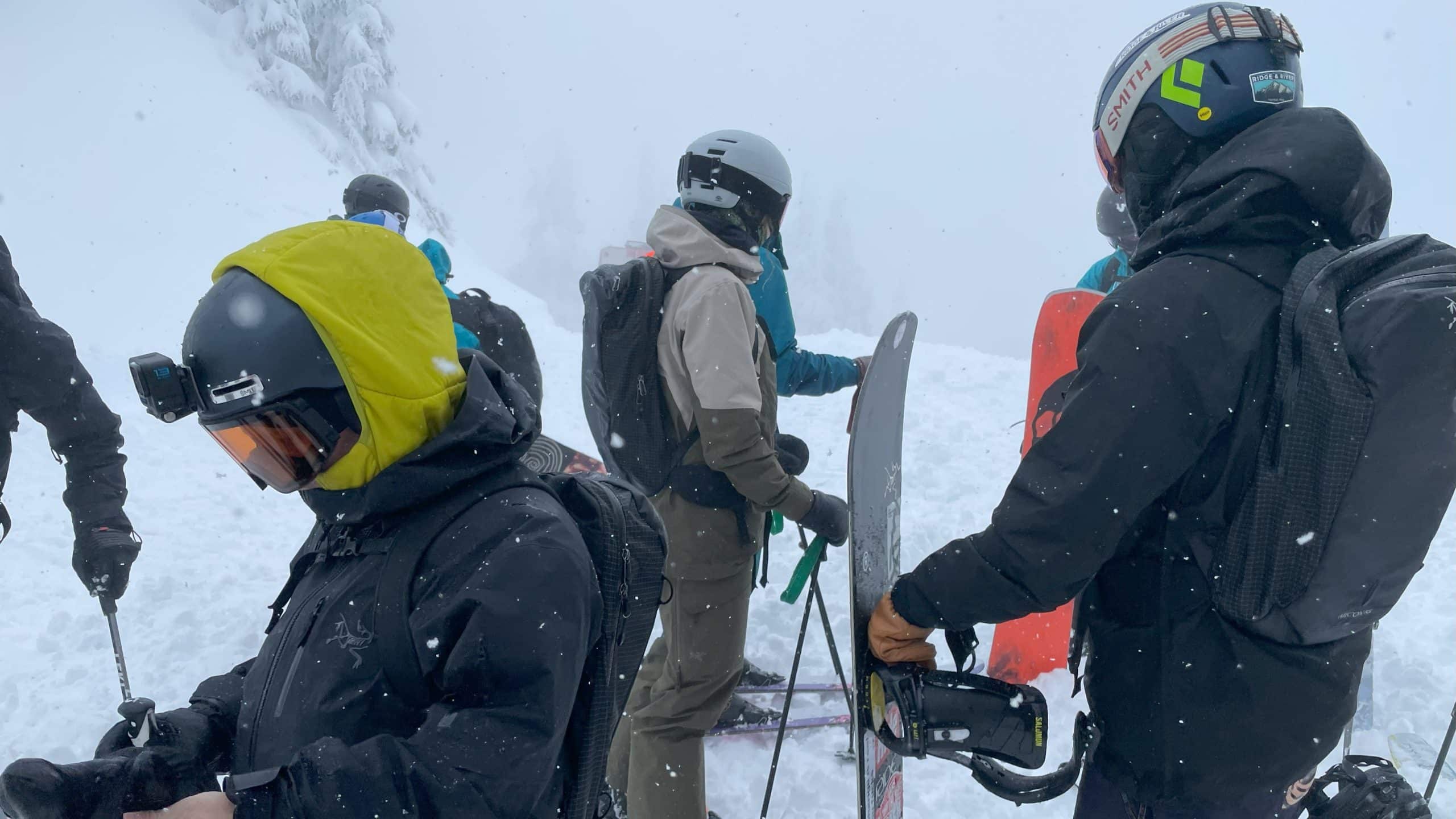 A group of backcountry skiers and snowboarders.