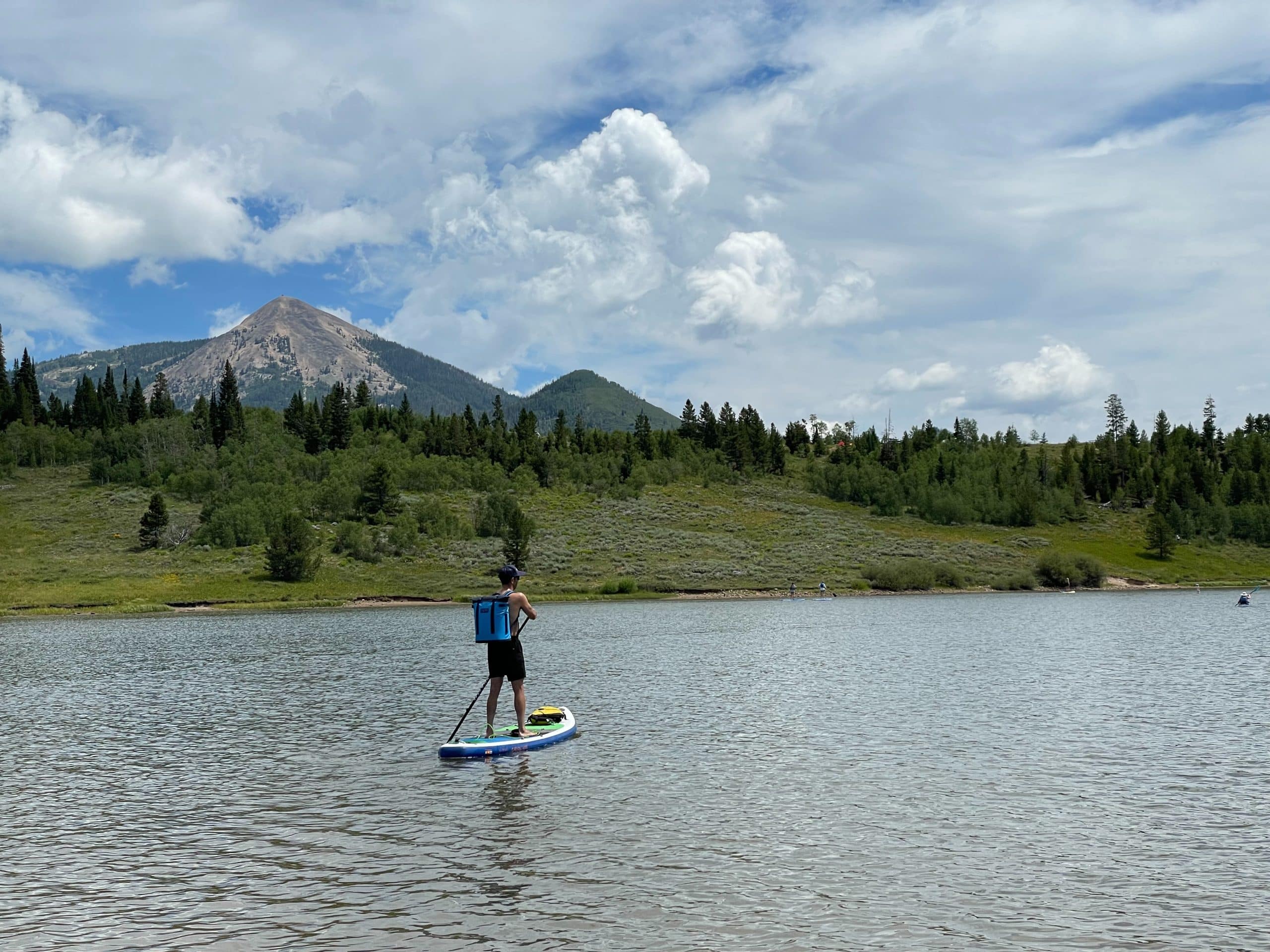 Paddling a paddle board wearing the YETI Hopper m20 backpack cooler.