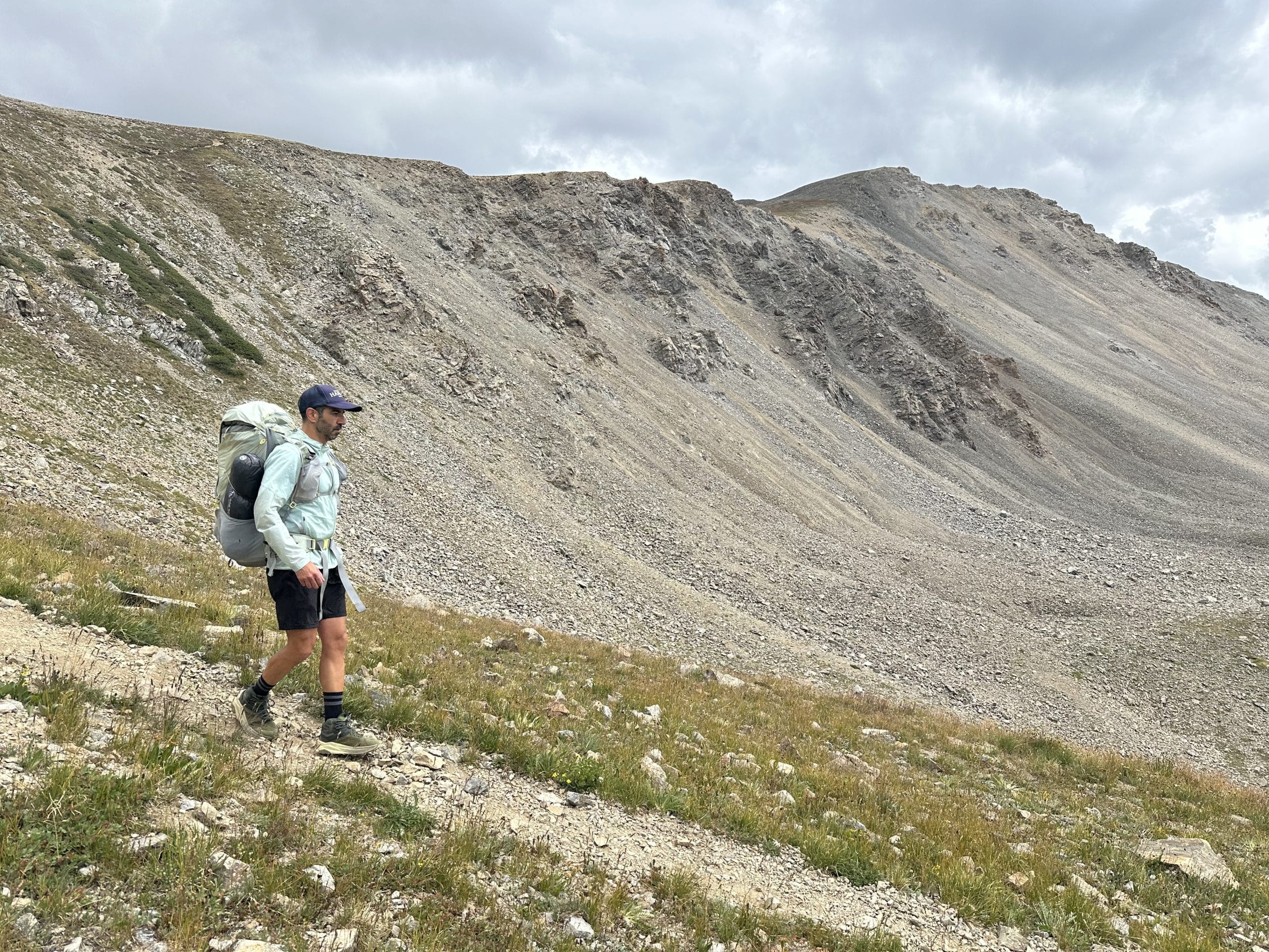 Navigating a loose descent wearing the Altra Olympus 6 Hike Mid GTX