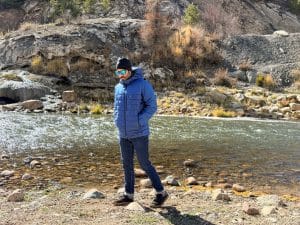 Walking by a river wearing the Patagonia Hi-Loft Nano Puff Hoody.
