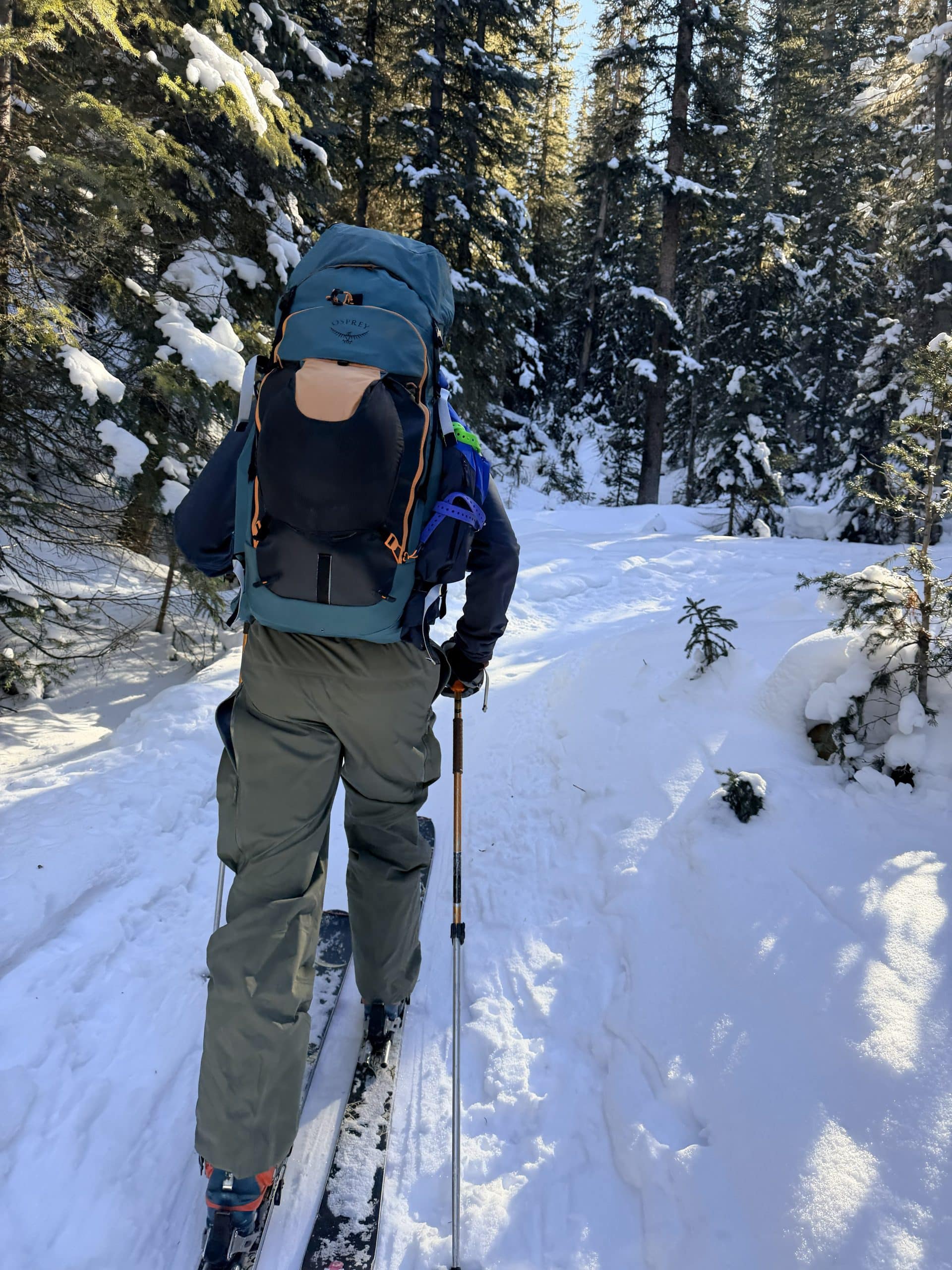 A skier touring with the Osprey Soelden 45L ski pack.