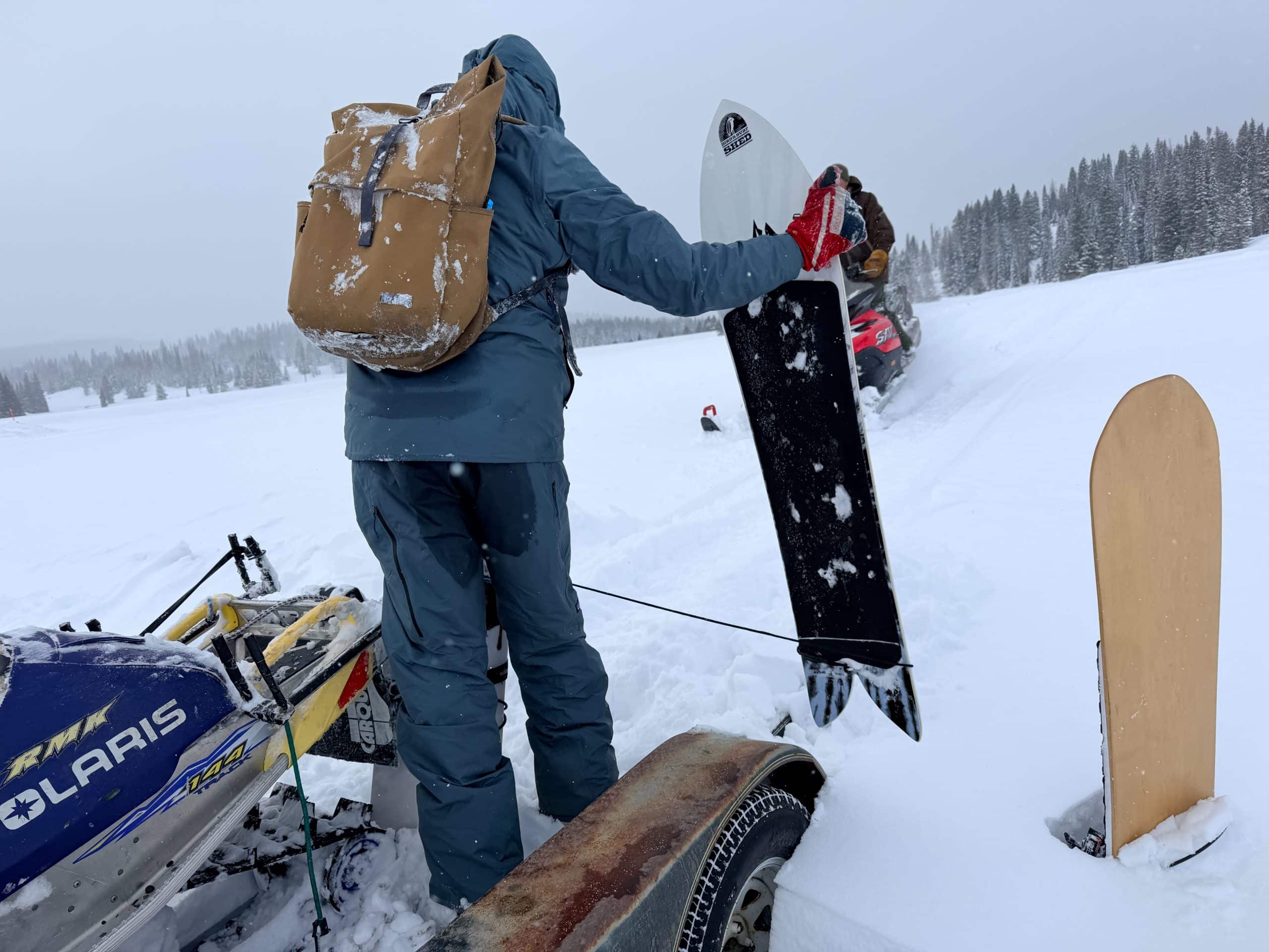 An image showing the seat of the Patagonia Insulated Powder Town Pants wet from sitting on a snowmobile.