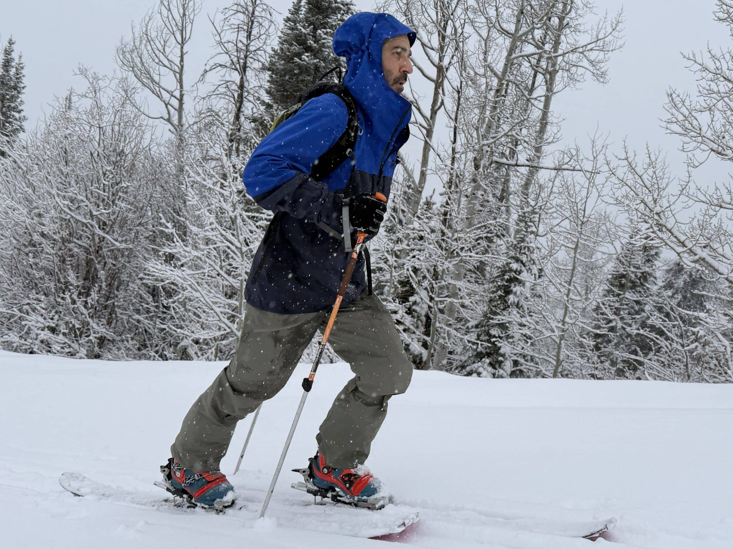 A skier touring while wearing the Arc'teryx Rush jacket and bibs.