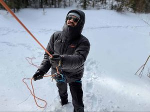 Belaying an ice climb wearing the Patagonia Grade VII Parka