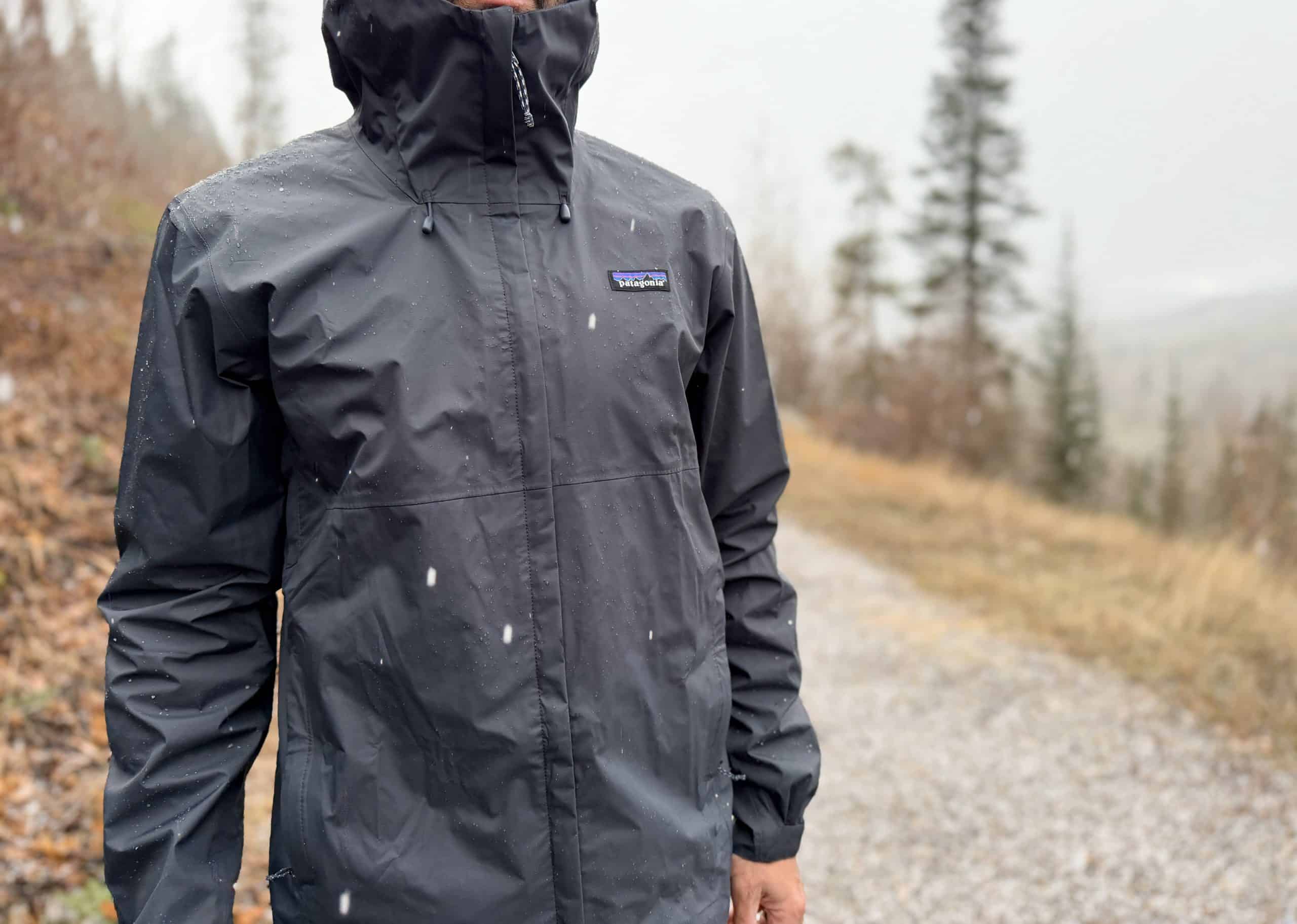 Man wearing a Patagonia Torrentshell 3L rain jacket in sleet and rain.