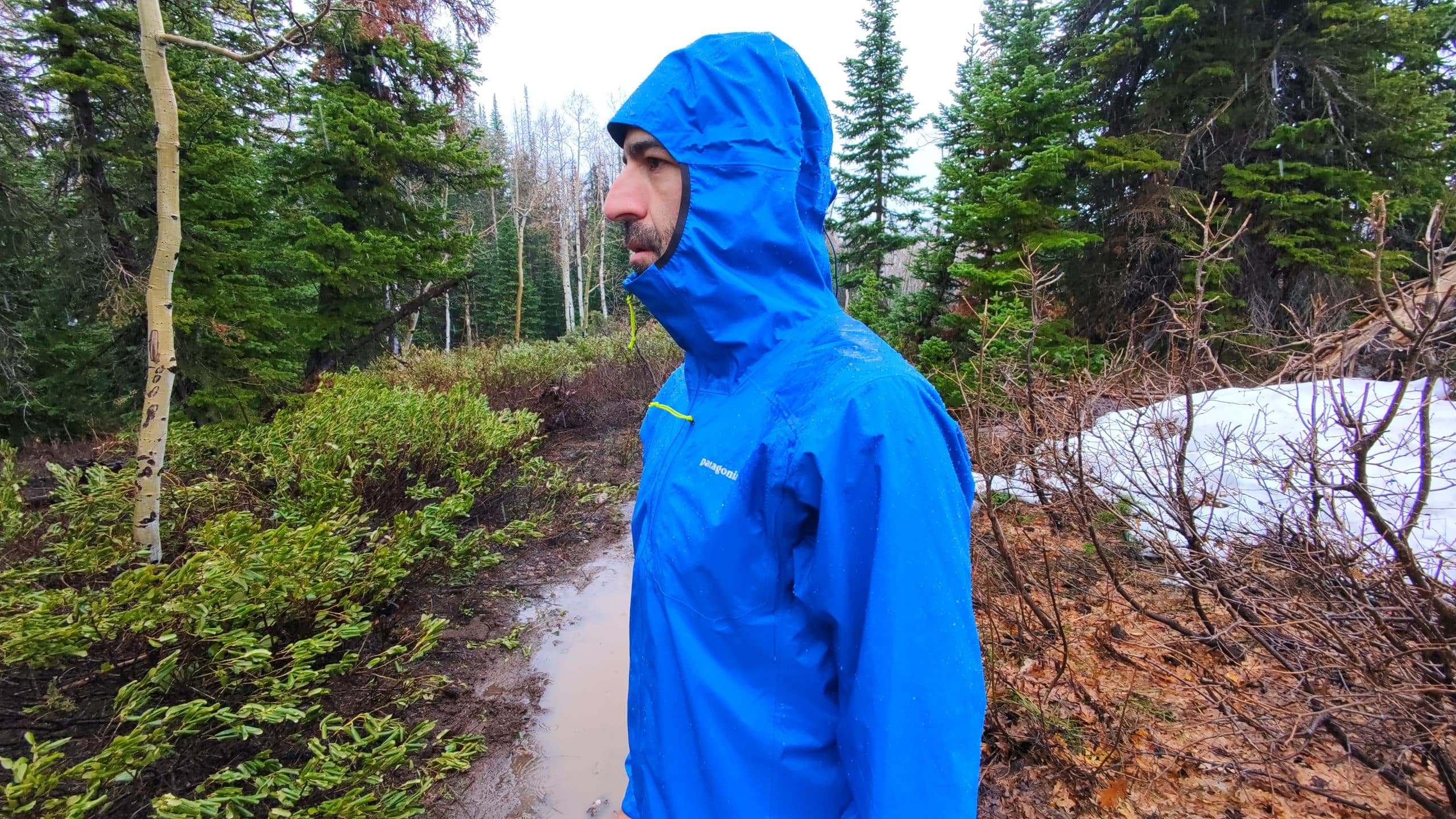 A profile shot of a trail runner to show the hood of the Patagonia Storm Racer jacket.