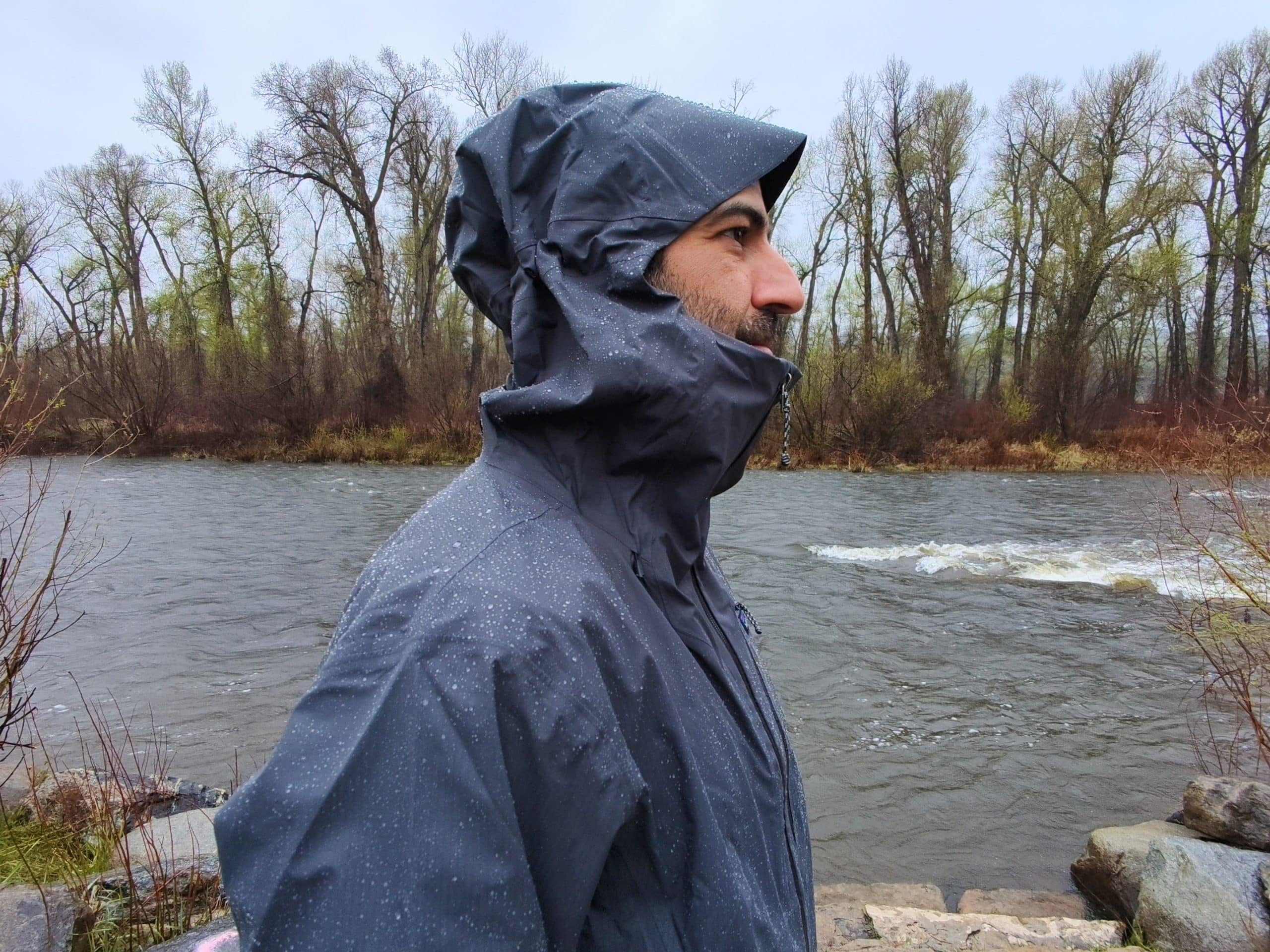 A profile image of a man wearing the Patagonia Granite Crest rain jacket to show the hood.