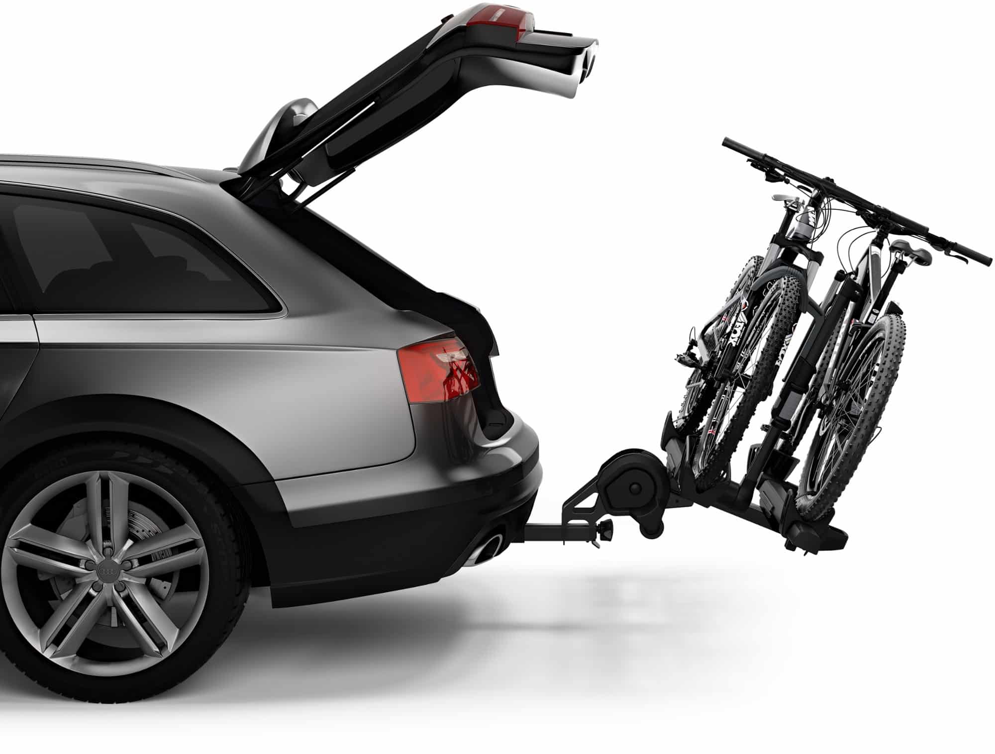 The Thule T2 XTR hitch rack in tilt mode with a car's rear hatch open.